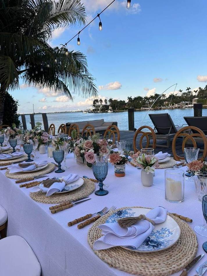 Daytime bayfront table, blue glassware. Chef Tasos Luxury Dining, Miami