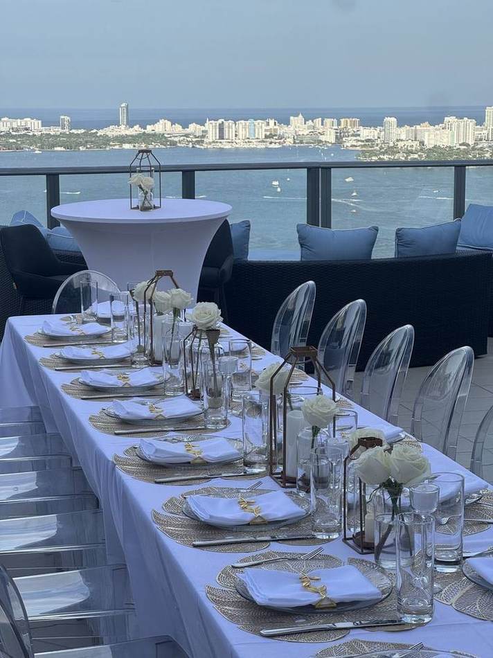 Long table, bay and skyline. Chef Tasos Luxury Dining, Miami