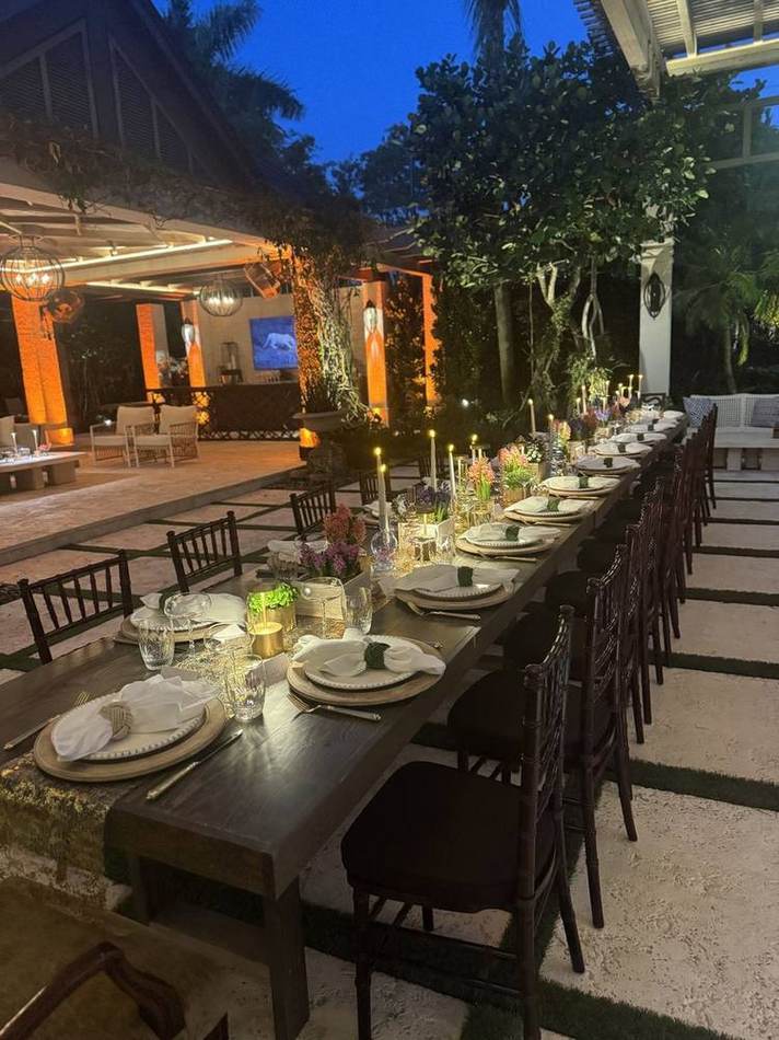 Garden table at night, warm light. Chef Tasos Luxury Dining, Miami