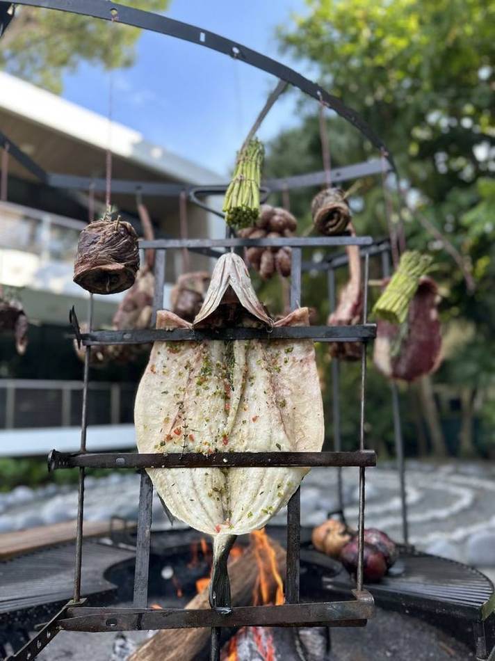 Cross-grill asado over open fire. Chef Tasos Luxury Dining, Miami