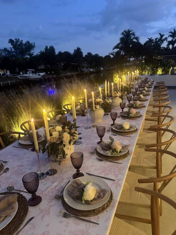 Sunset table on the water, candles. Chef Tasos Luxury Dining, Miami