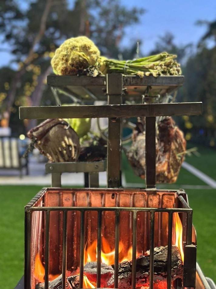 Asado over open fire, garden. Chef Tasos Luxury Dining, Miami