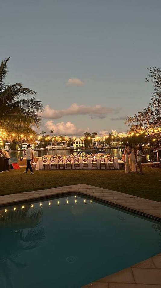 Poolside at sunset, palms. Chef Tasos Luxury Dining, Miami