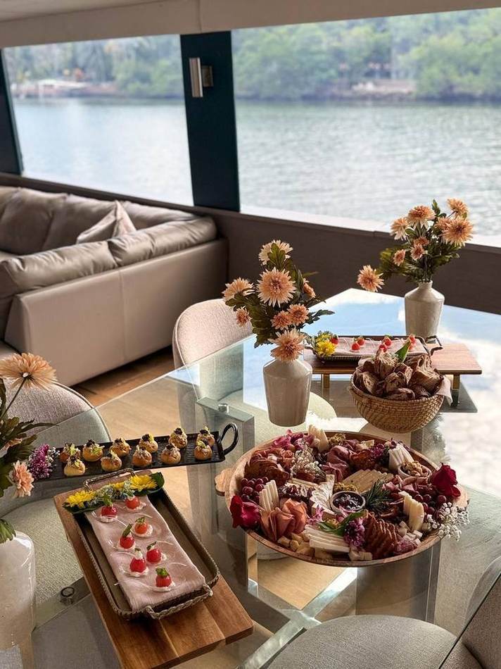 Yacht deck with boards, water behind. Chef Tasos Luxury Dining, Miami