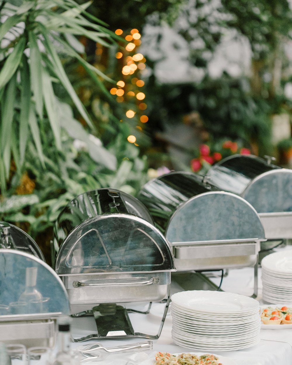 Chafing dishes and plates set out before service