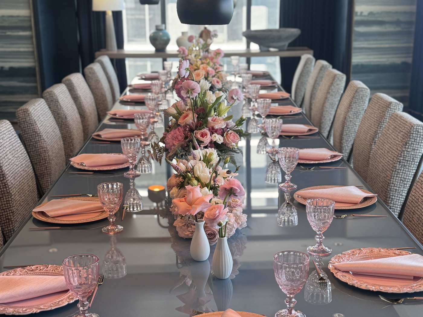 Private dining room in a Miami residence set for a resident dinner, city view behind